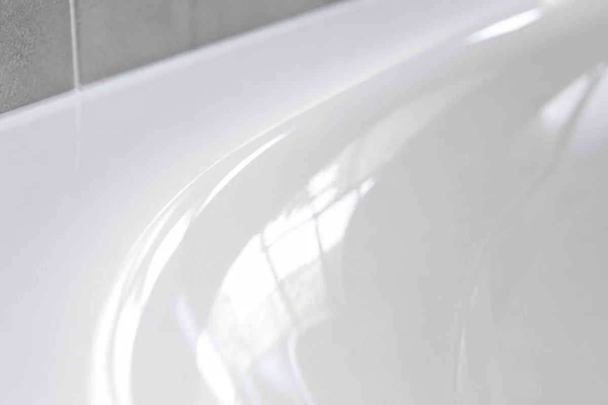 Close-up of a durable glossy reglazed white bathtub finish in a San Jose home